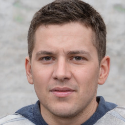 Joyful white young-adult male with short  brown hair and grey eyes