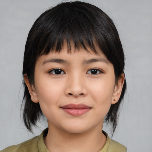 Joyful asian child female with medium  brown hair and brown eyes