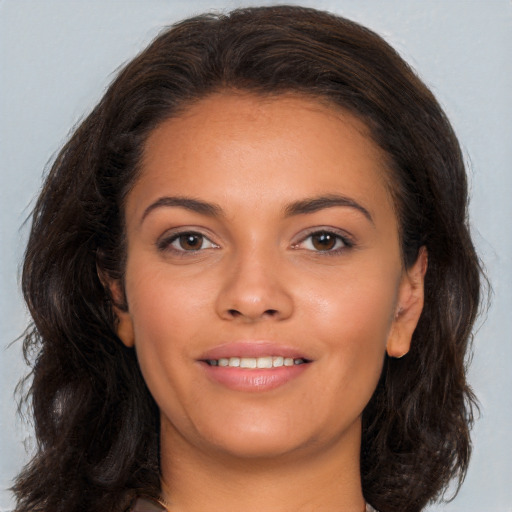 Joyful latino young-adult female with long  brown hair and brown eyes