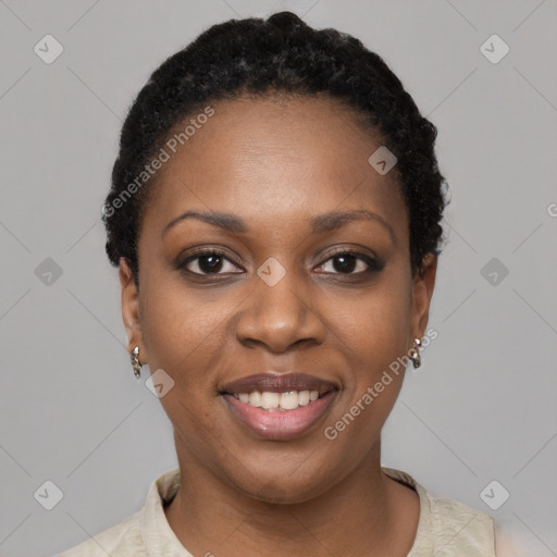 Joyful black young-adult female with short  black hair and brown eyes