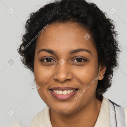 Joyful black young-adult female with long  brown hair and brown eyes