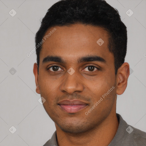 Joyful black young-adult male with short  black hair and brown eyes