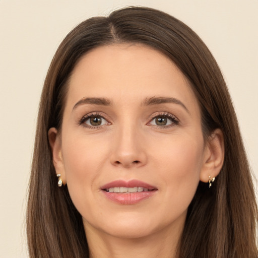 Joyful white young-adult female with long  brown hair and brown eyes