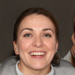 Joyful white adult female with medium  brown hair and blue eyes