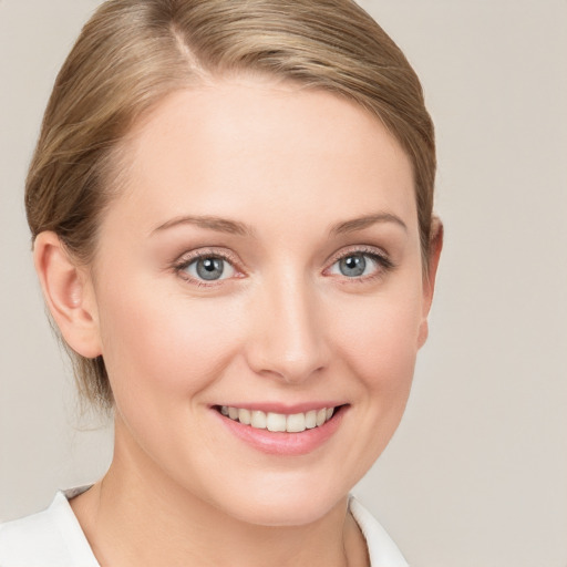 Joyful white young-adult female with medium  brown hair and blue eyes