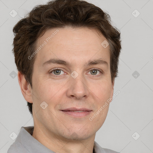 Joyful white adult male with short  brown hair and grey eyes