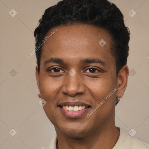 Joyful black young-adult male with short  black hair and brown eyes