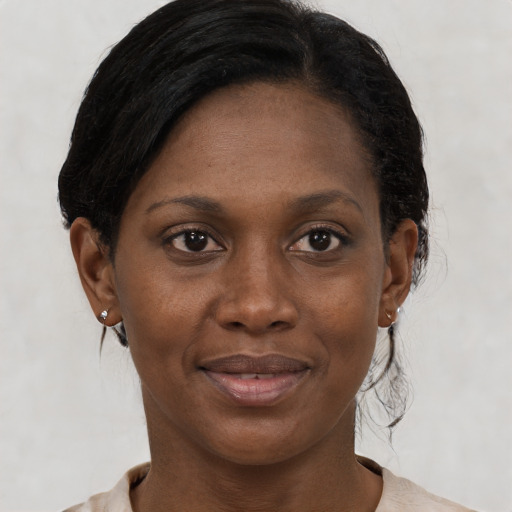 Joyful black young-adult female with medium  brown hair and brown eyes