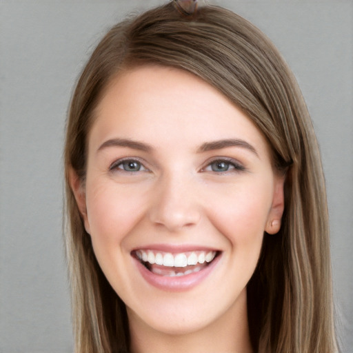 Joyful white young-adult female with long  brown hair and grey eyes