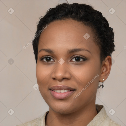 Joyful black young-adult female with short  black hair and brown eyes