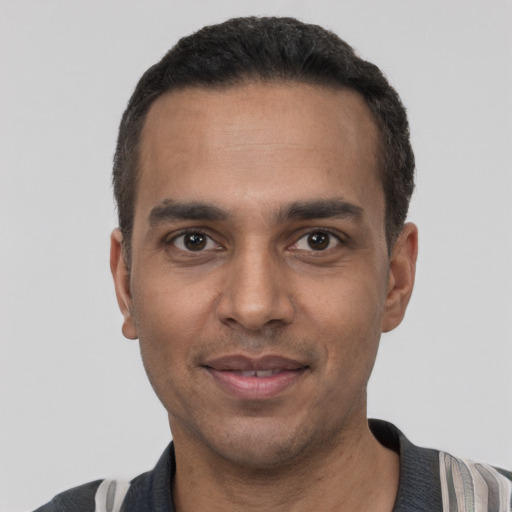 Joyful white young-adult male with short  black hair and brown eyes