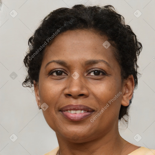 Joyful black adult female with short  brown hair and brown eyes