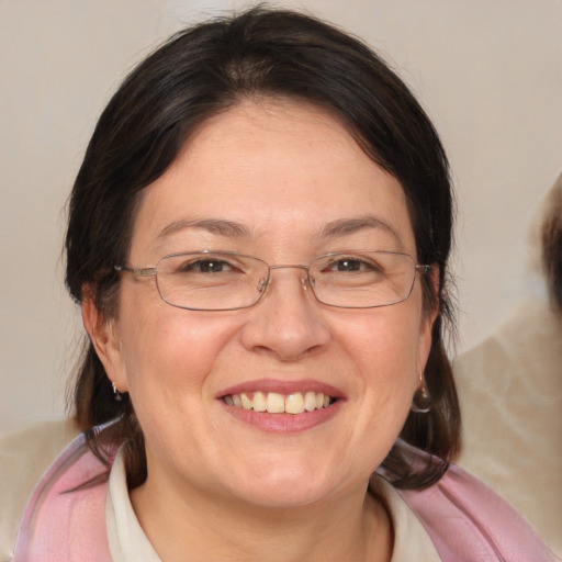 Joyful white adult female with medium  brown hair and blue eyes