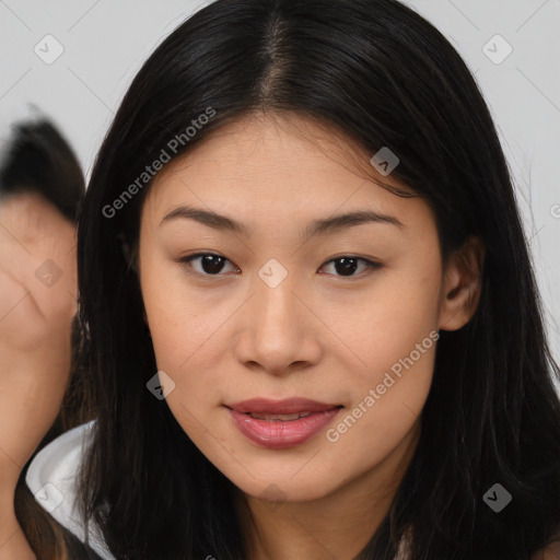 Joyful asian young-adult female with long  brown hair and brown eyes