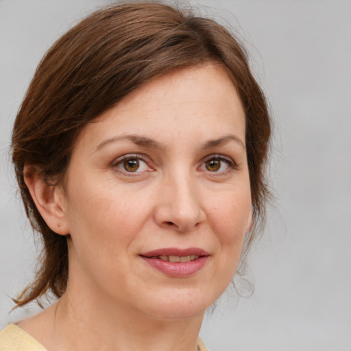 Joyful white adult female with medium  brown hair and brown eyes