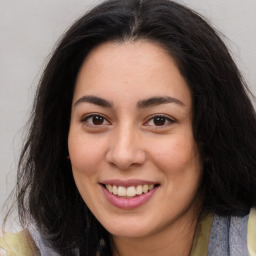 Joyful latino young-adult female with long  brown hair and brown eyes