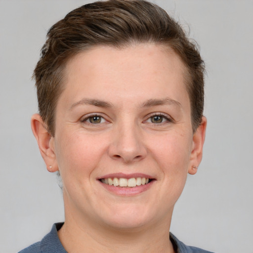 Joyful white adult female with short  brown hair and grey eyes