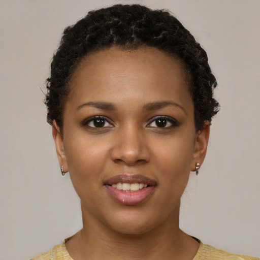 Joyful black young-adult female with short  brown hair and brown eyes