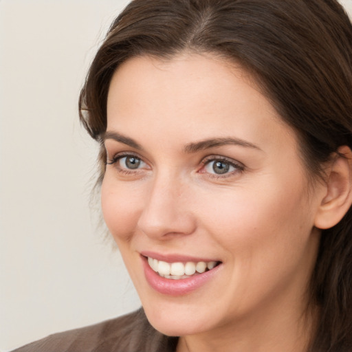 Joyful white young-adult female with medium  brown hair and brown eyes