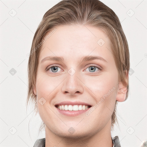 Joyful white young-adult female with medium  brown hair and blue eyes