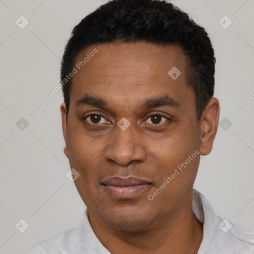Joyful latino adult male with short  black hair and brown eyes