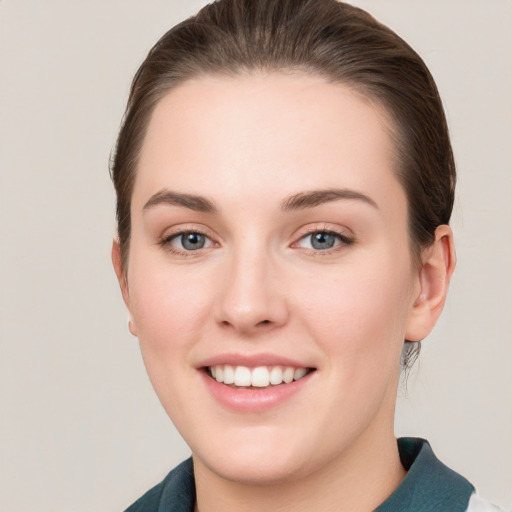 Joyful white young-adult female with short  brown hair and grey eyes