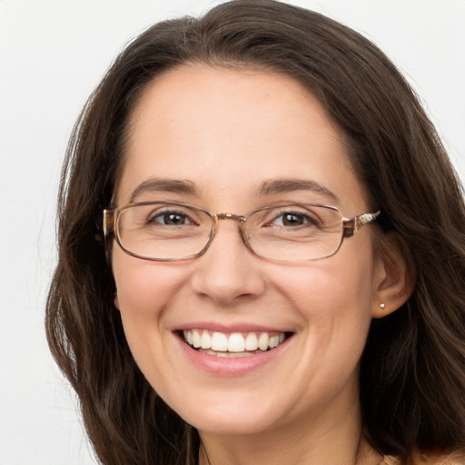 Joyful white adult female with long  brown hair and grey eyes