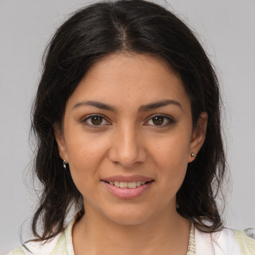 Joyful latino young-adult female with medium  brown hair and brown eyes