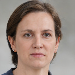 Joyful white adult female with medium  brown hair and grey eyes