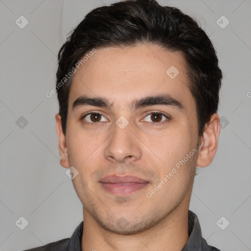 Joyful white young-adult male with short  black hair and brown eyes