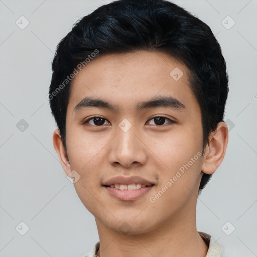 Joyful asian young-adult male with short  black hair and brown eyes