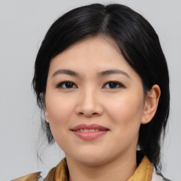 Joyful asian young-adult female with medium  black hair and brown eyes