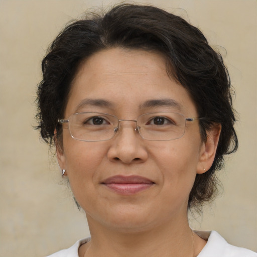 Joyful asian adult female with medium  brown hair and brown eyes