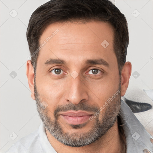 Joyful white adult male with short  brown hair and brown eyes