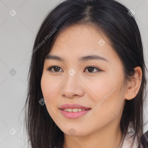 Joyful asian young-adult female with long  brown hair and brown eyes