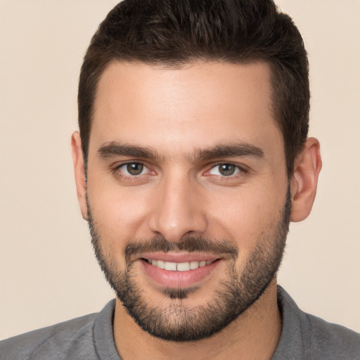 Joyful white young-adult male with short  brown hair and brown eyes