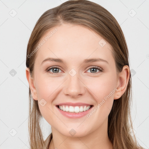 Joyful white young-adult female with long  brown hair and blue eyes