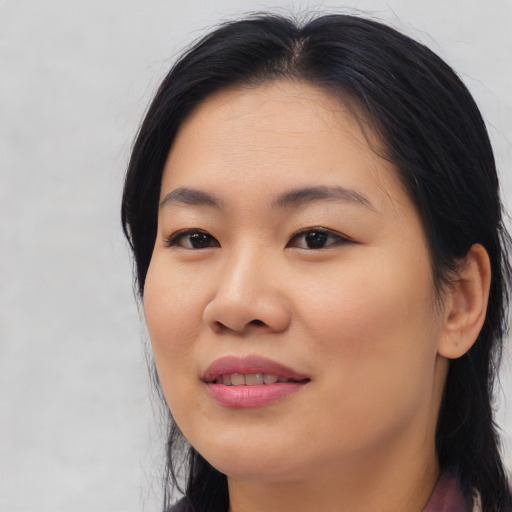 Joyful asian young-adult female with medium  black hair and brown eyes