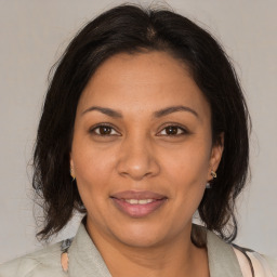 Joyful black adult female with medium  brown hair and brown eyes