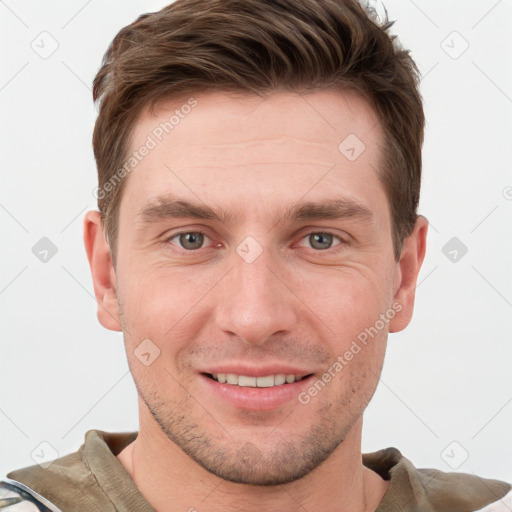 Joyful white young-adult male with short  brown hair and grey eyes