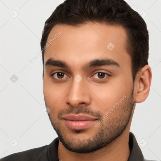 Joyful white young-adult male with short  brown hair and brown eyes