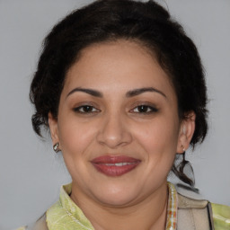 Joyful latino adult female with medium  brown hair and brown eyes