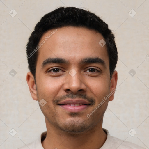 Joyful latino young-adult male with short  black hair and brown eyes