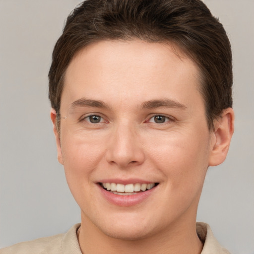 Joyful white young-adult female with short  brown hair and brown eyes