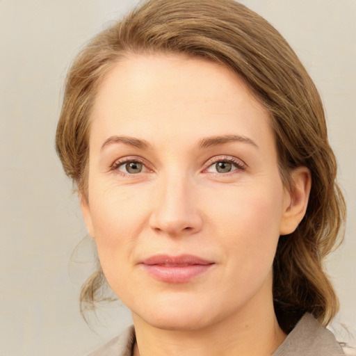 Joyful white young-adult female with medium  brown hair and green eyes