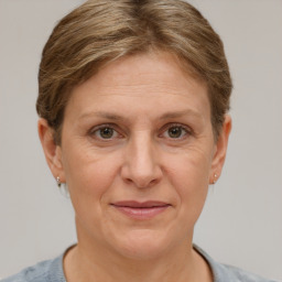 Joyful white adult female with short  brown hair and grey eyes