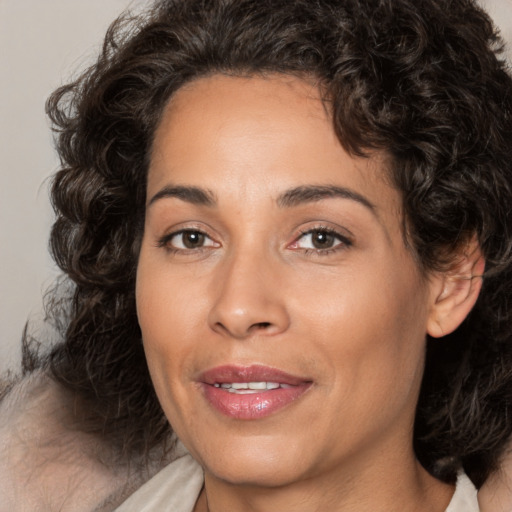 Joyful white adult female with medium  brown hair and brown eyes