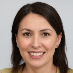 Joyful white adult female with medium  brown hair and brown eyes