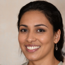 Joyful latino young-adult female with medium  brown hair and brown eyes