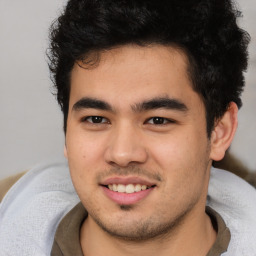 Joyful latino young-adult male with short  brown hair and brown eyes